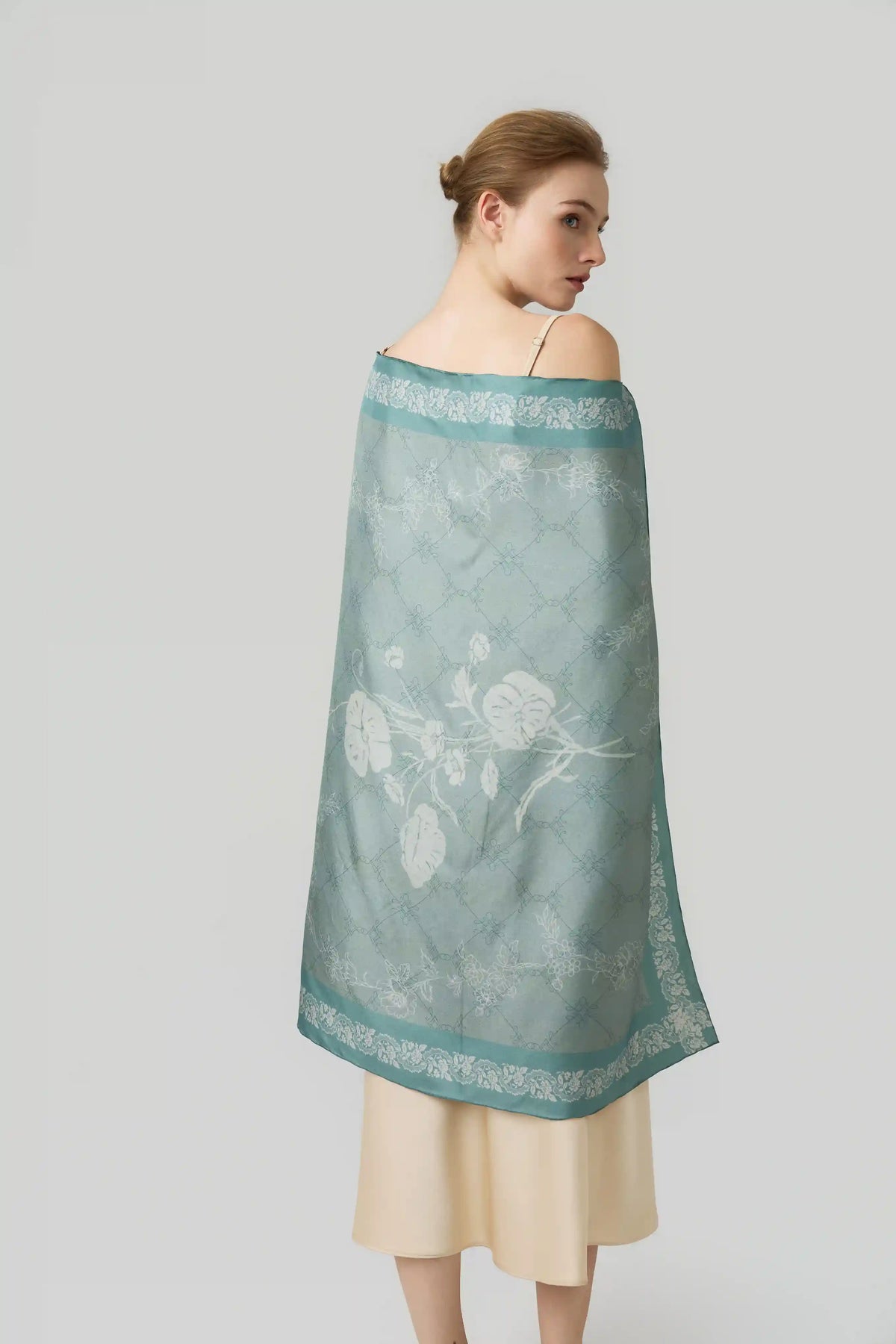 Hand-rolled silk square scarf in sage green floral print, draped