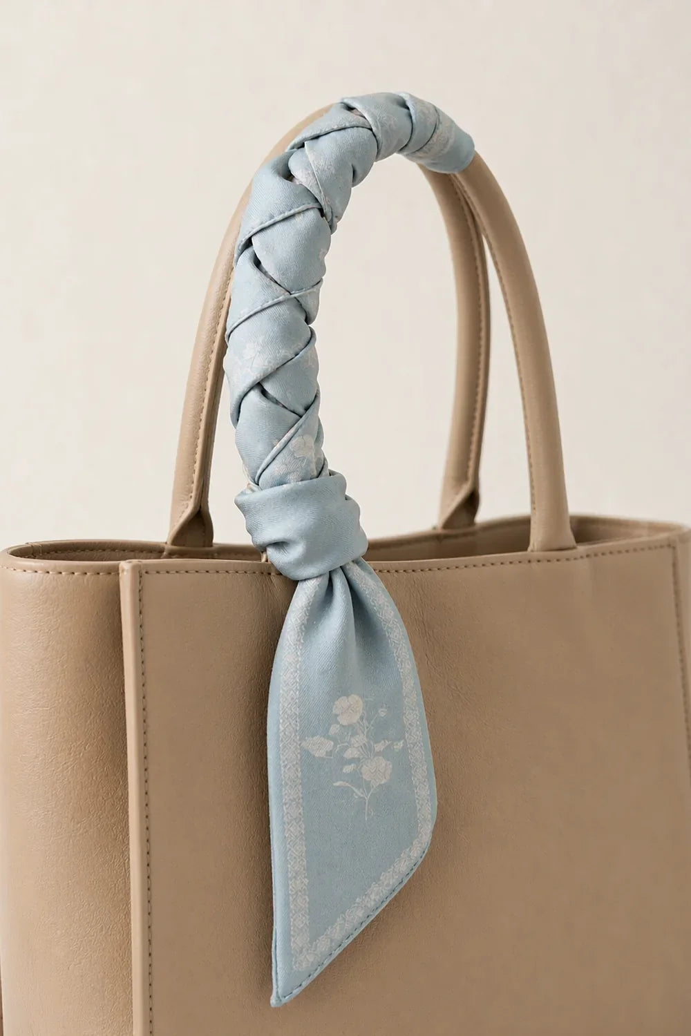 Silk twilly wrapped around a tote bag handle