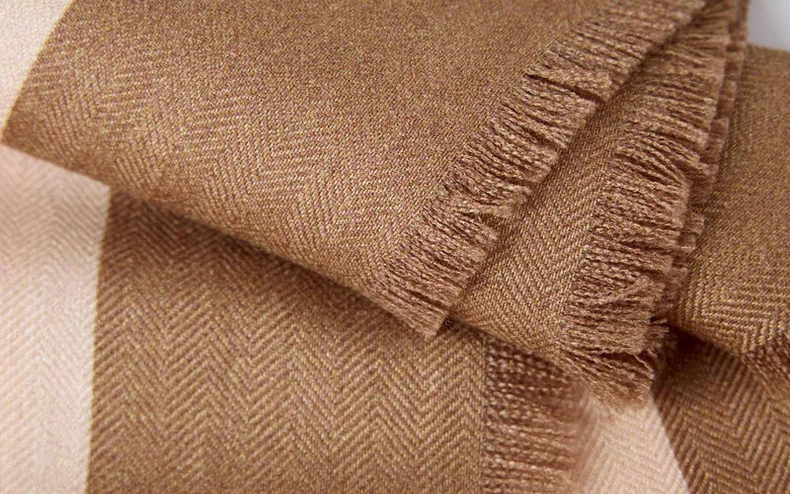 Texture close-up of an ASYII silk-wool blend showing its fine, soft weave