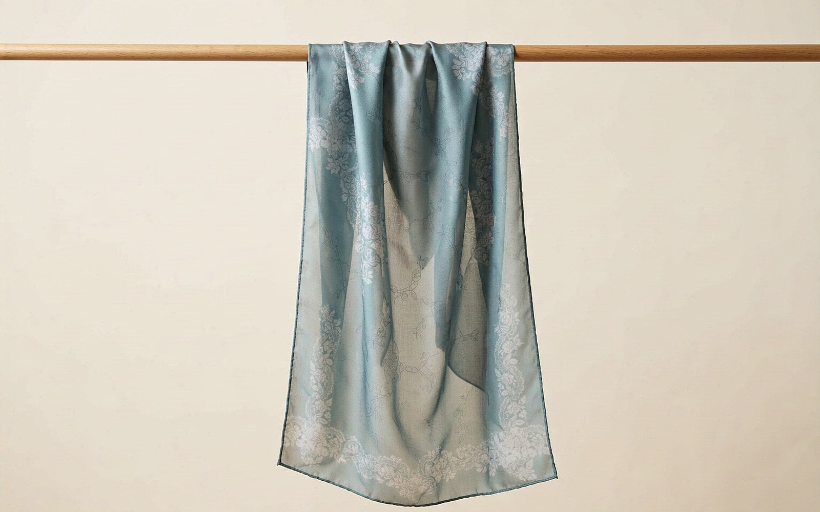 Mulberry silk square scarf hanging vertically with light passing through the print